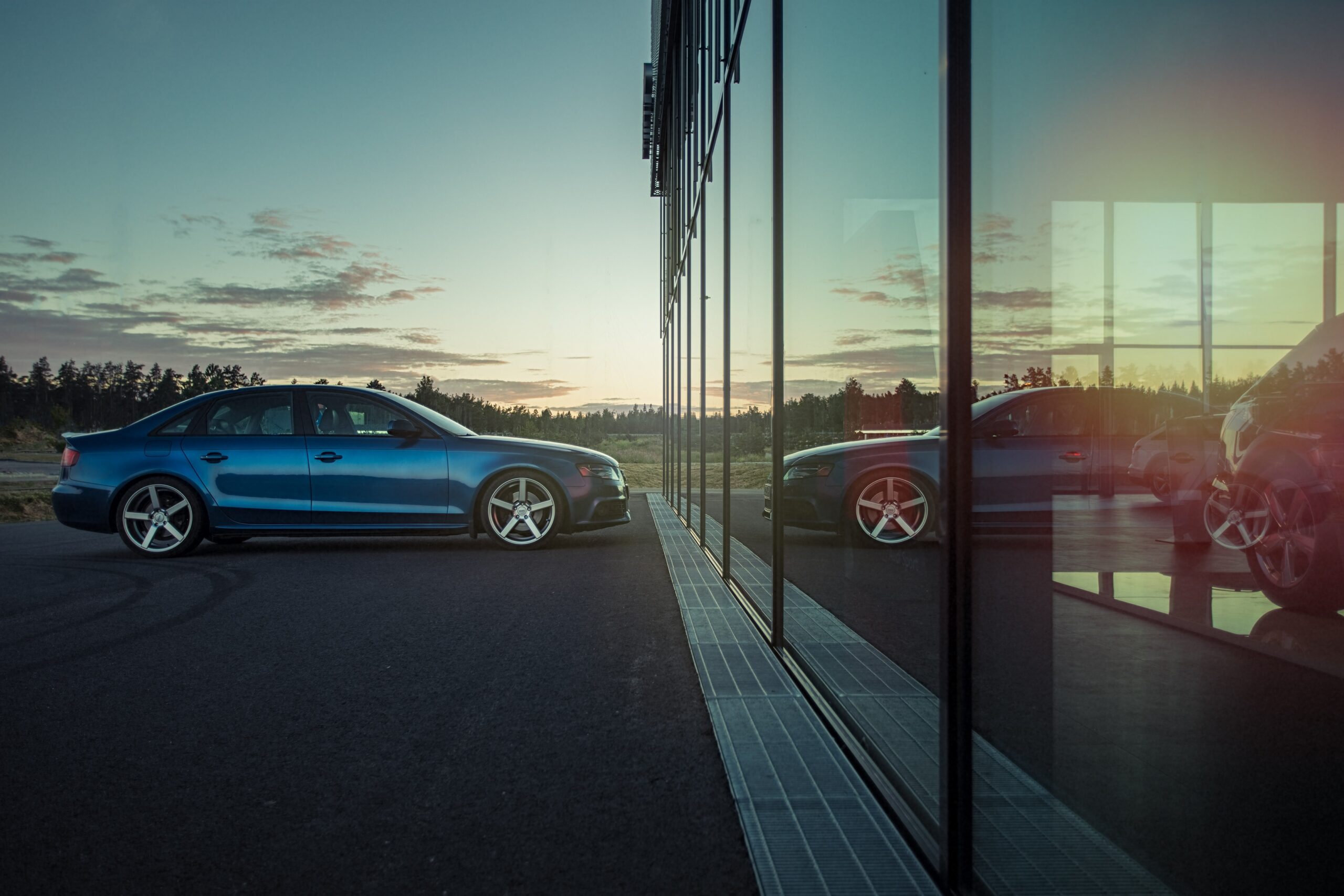 A nice car in a dealer lot at sunset