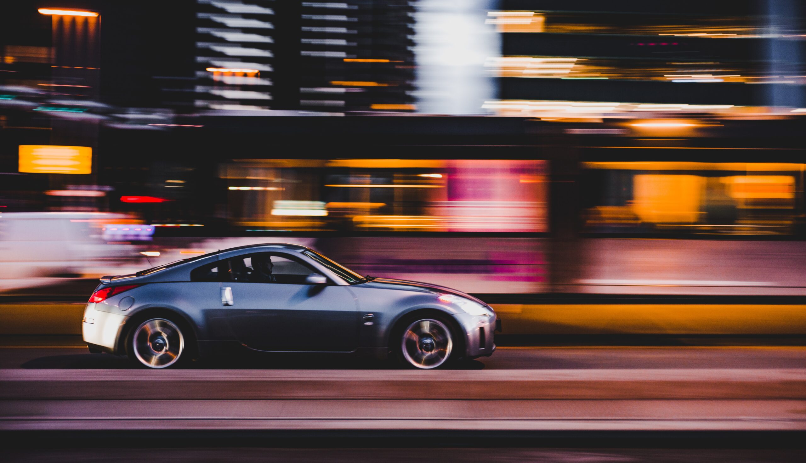car driving quickly on a night road